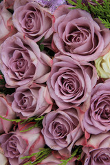 Purple roses in a wedding arrangement