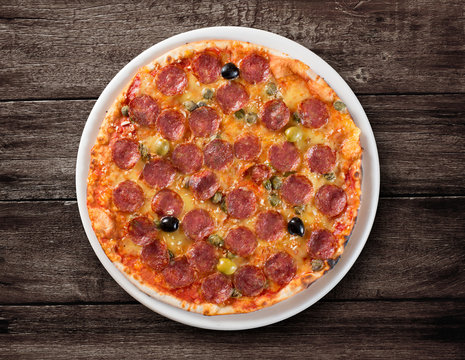 Italian salami pizza top view on wooden table