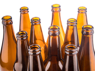 Brown beer bottles stacked isolated on white background