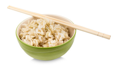 Brown rice with chopsticks in a cup on white background