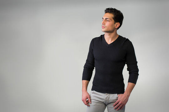 Handsome Latin Young Man Standing On Grey Background.