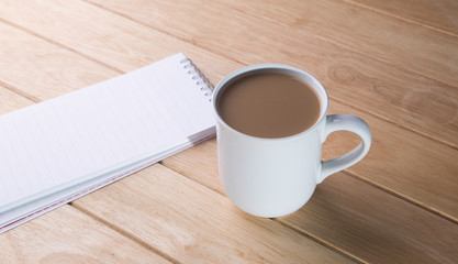 coffee cup with notebooks.