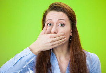 Woman covering mouth with on eland, speak no evil