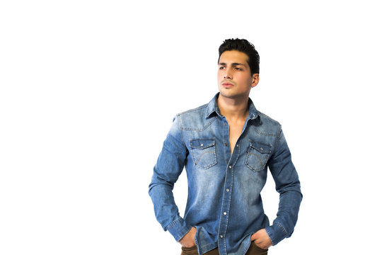 Young Man Wearing Denim Shirt, Hands In Pockets