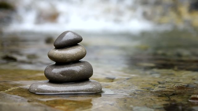 Stacked pebbles and flowing river