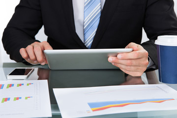 Hands of a businessman using a tablet computer