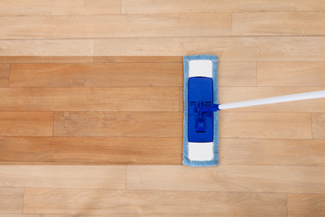 Mop cleaning a wooden floor