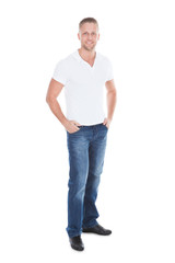 Fototapeta premium Relaxed sexy attractive young man in jeans and a white t-shirt
