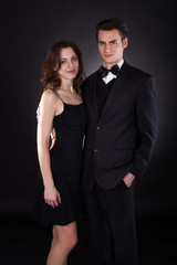 Elegant Couple Standing Over Black Background