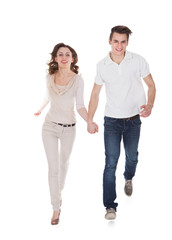 Couple In Casuals Walking Over White Background