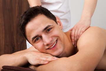 Fototapeta na wymiar Man Receiving Shoulder Massage In Spa