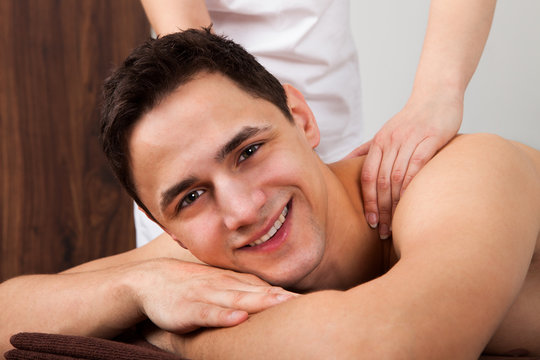 Man Receiving Shoulder Massage In Spa