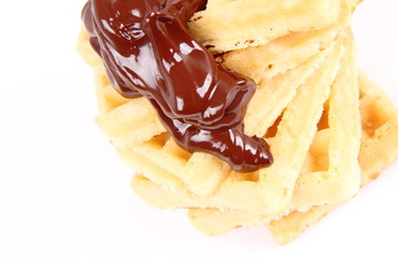 Waffles covered with chocolate on a white background