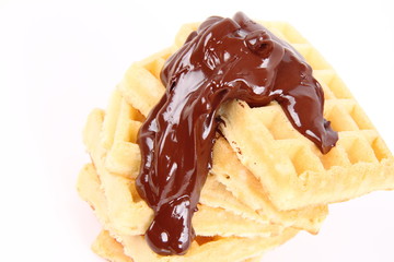 Waffles covered with chocolate on a white background