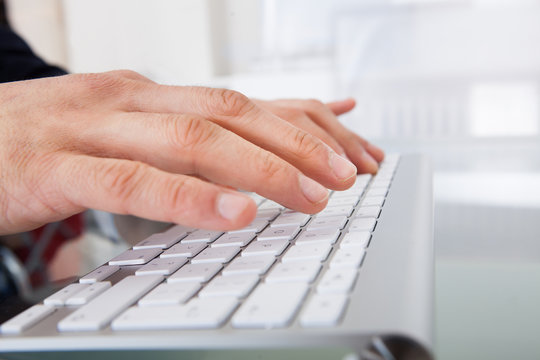 Businessman Typing On Keyboard At Desk