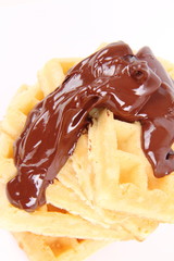 Waffles covered with chocolate on a white background