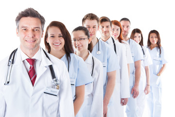 Long line of smiling doctors and nurses