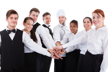Waiters and waitresses stacking hands