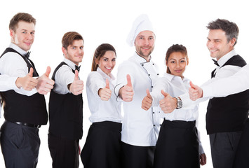 Fototapeta na wymiar Waiters and waitresses showing thumbs up sign