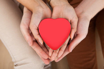 Couple Holding Heart Shape In Cupped Hands