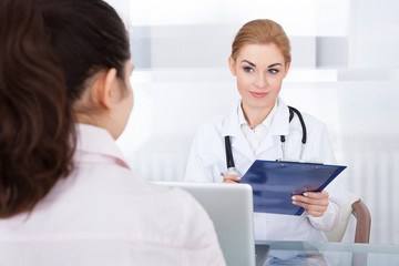 Female Doctor Talking With Patient