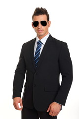 Standing handsome businessman in suit with sunglasses