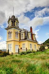 Haunted house by a large grassy field