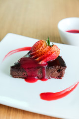 Chocolate Cake topping with sliced strawberry