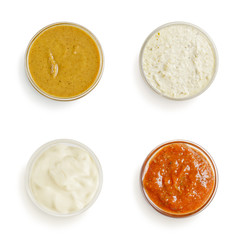sauces in a gravy boat on white background