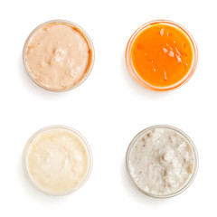 sauces in a gravy boat on white background