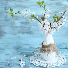 blossom apple tree in vase on blue background