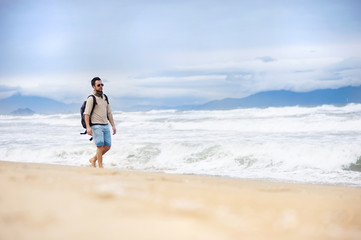 Fototapeta na wymiar Man walking on the beach