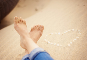 Closeup of female feet at the beach