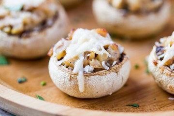 Mushroom champignons stuffed with filling of chicken, cheese