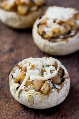 Mushroom champignons stuffed with filling of chicken, cheese