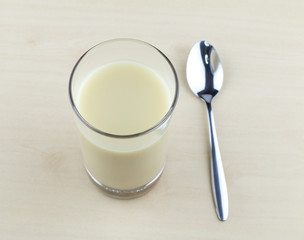 Glass of soy milk with spoon