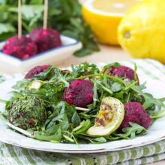 Fresh summer salad with arugula, zucchini, balls of beet