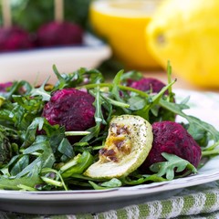 Fresh summer salad with arugula, zucchini, balls of beet