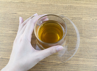 Holding a glass cup tea