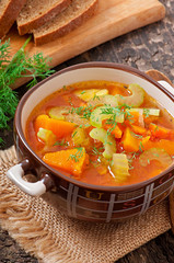 Vegetable soup on the old wooden background