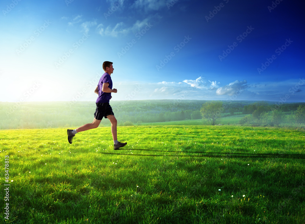 Wall mural sunset and running young man