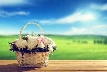 Fototapeta na wymiar flowers on table and spring field