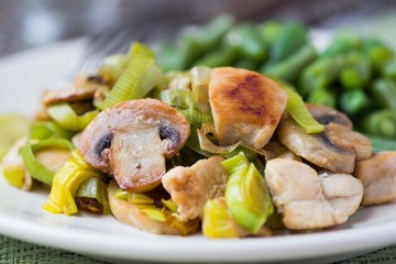 Chicken fillet fried with leek, mushrooms, green beans, sauce