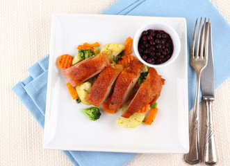 Roasted duck breast with vegetables, wild blueberries
