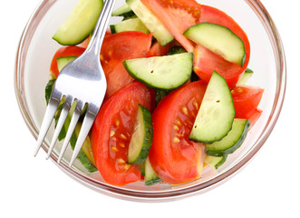 Fresh salad with tomatoes and cucumbers isolated on white