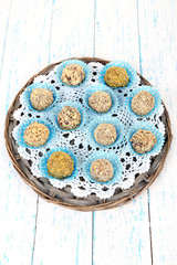 Set of chocolate candies, on wicker mat, on wooden background