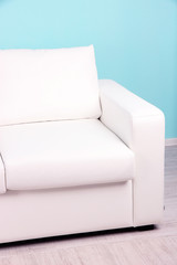 White sofa close-up in room on blue background