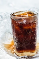 Glass of cola soda drink with ice cubes