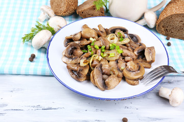 Delicious fried mushrooms on plate on table close-up