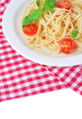 Delicious spaghetti with tomatoes on plate on table close-up